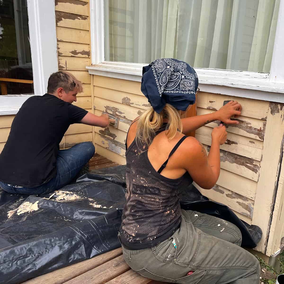 Man and Woman Scraping Paint