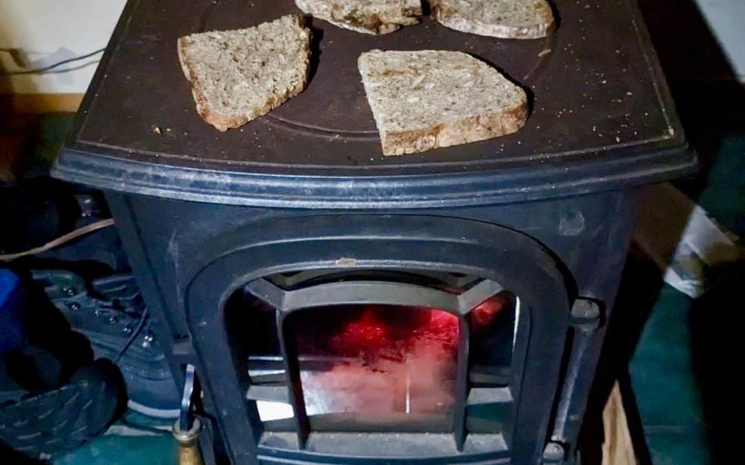 Wood burning stove from above with slices of bread warming on top
